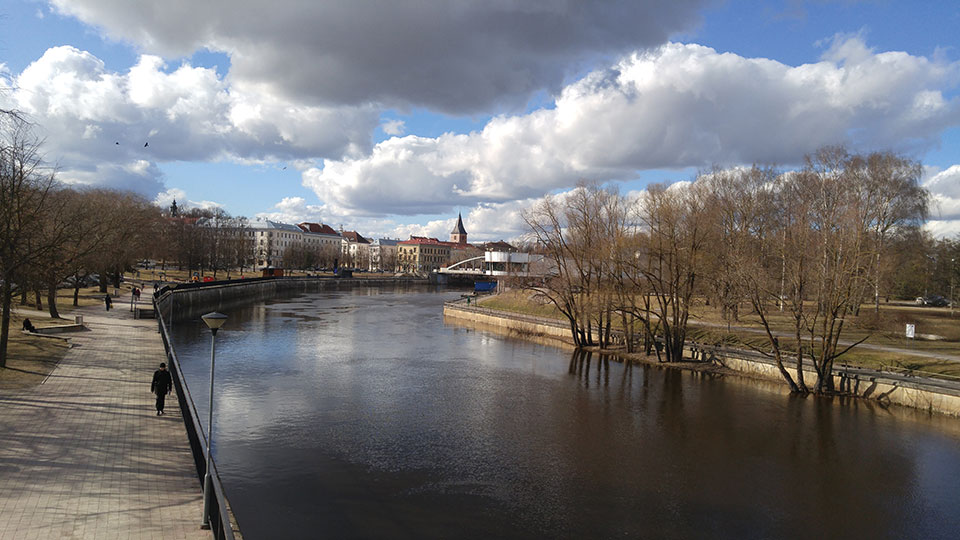 Trees line the bank of the Emajõgi river as it winds through Tartu, Estonia