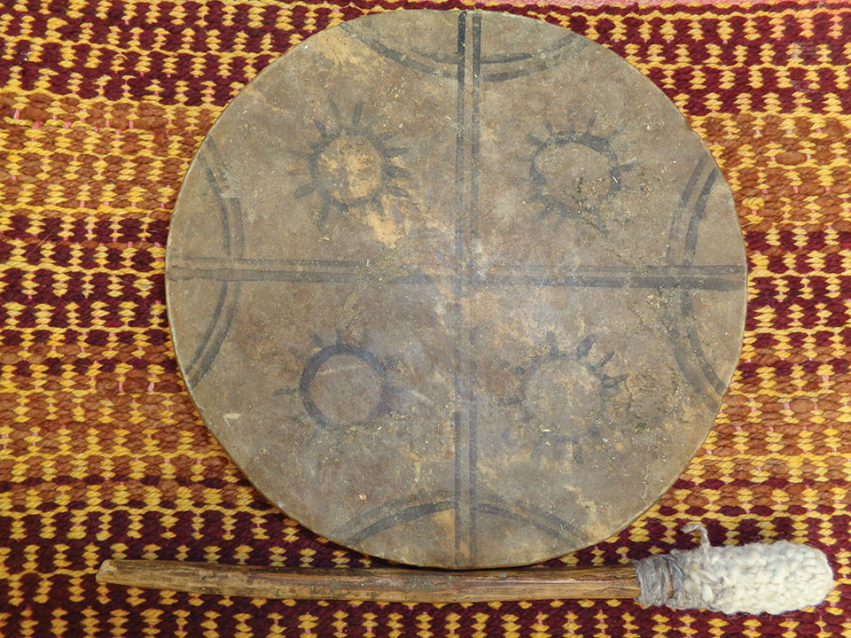 A drum of carved wood and animal hide, known as a kultrún.