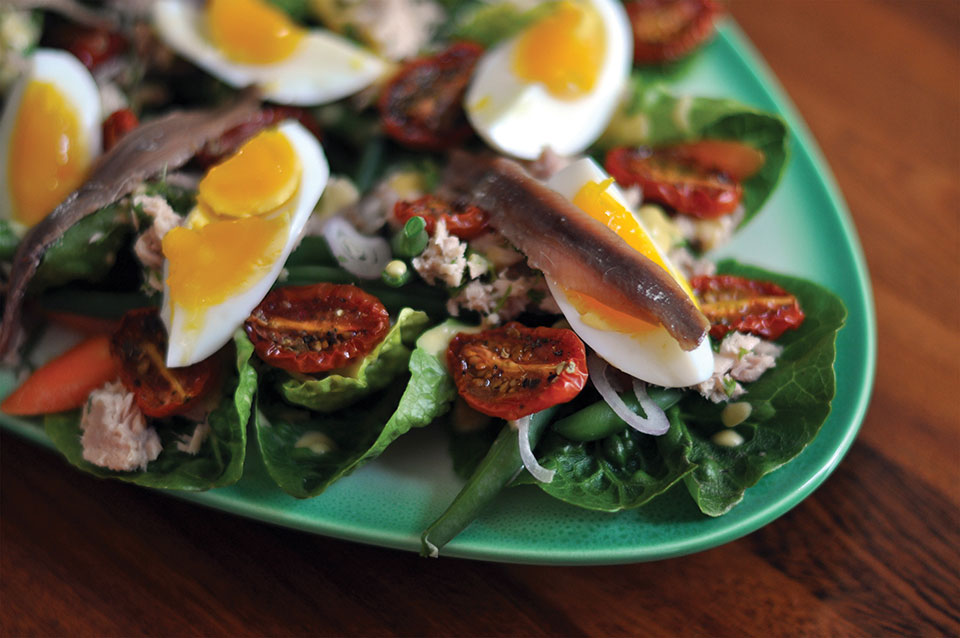 A close up photograph of a Nicoise salad