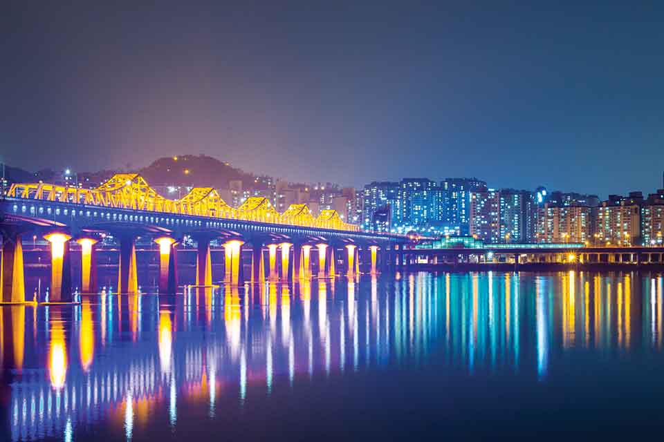 A city skyline reflected in a bay at night