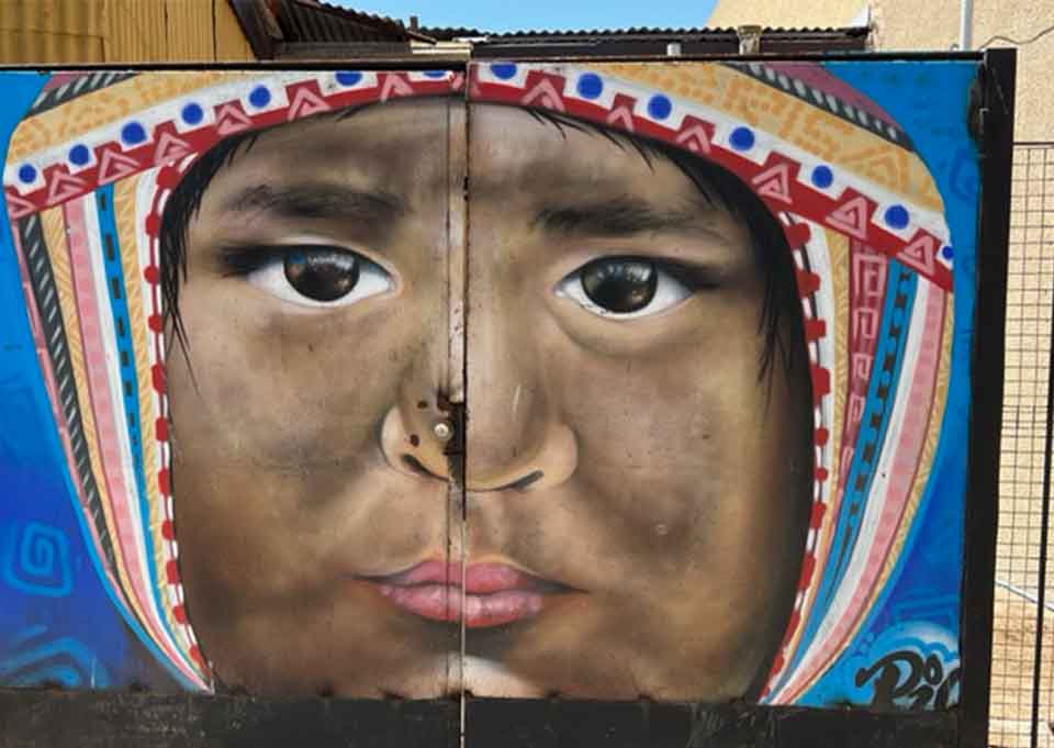 A photograph of a painting of a child on the side of a building