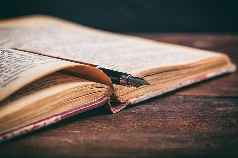 A photograph of an old book on a wooden desk