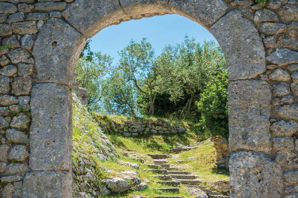 A photograph of a stone path running up the side of a rustic hill