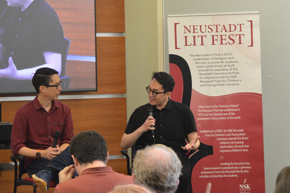 A photograph of Trung Lê Nguyễn and Gene Luen Yang talking at the 2023 Neustadt Lit Fest