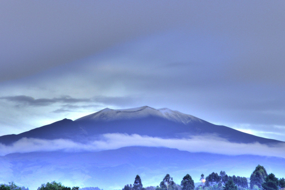 A photograph of a distant snow covered mountain top