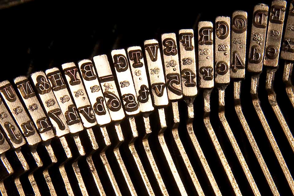 A photograph of the row of arms on a manual typewriter 