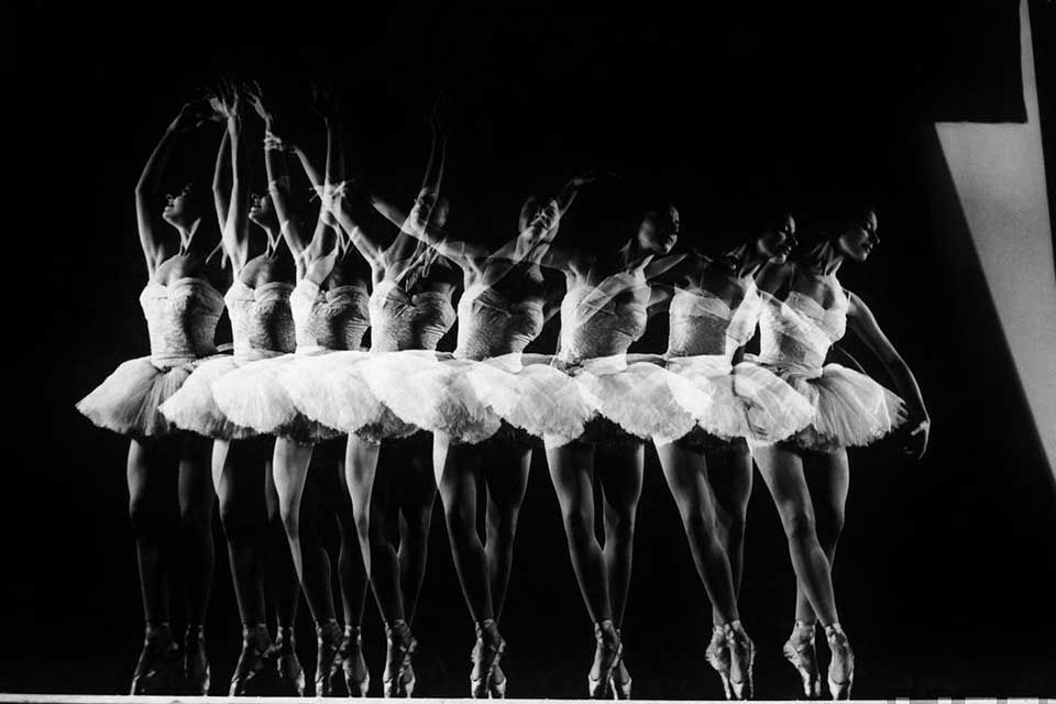 A time-elapsed black and white photograph of a dancer