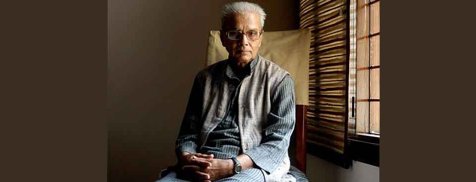 A photo of sitting looking at the camera with light coming in through the blinds to his right