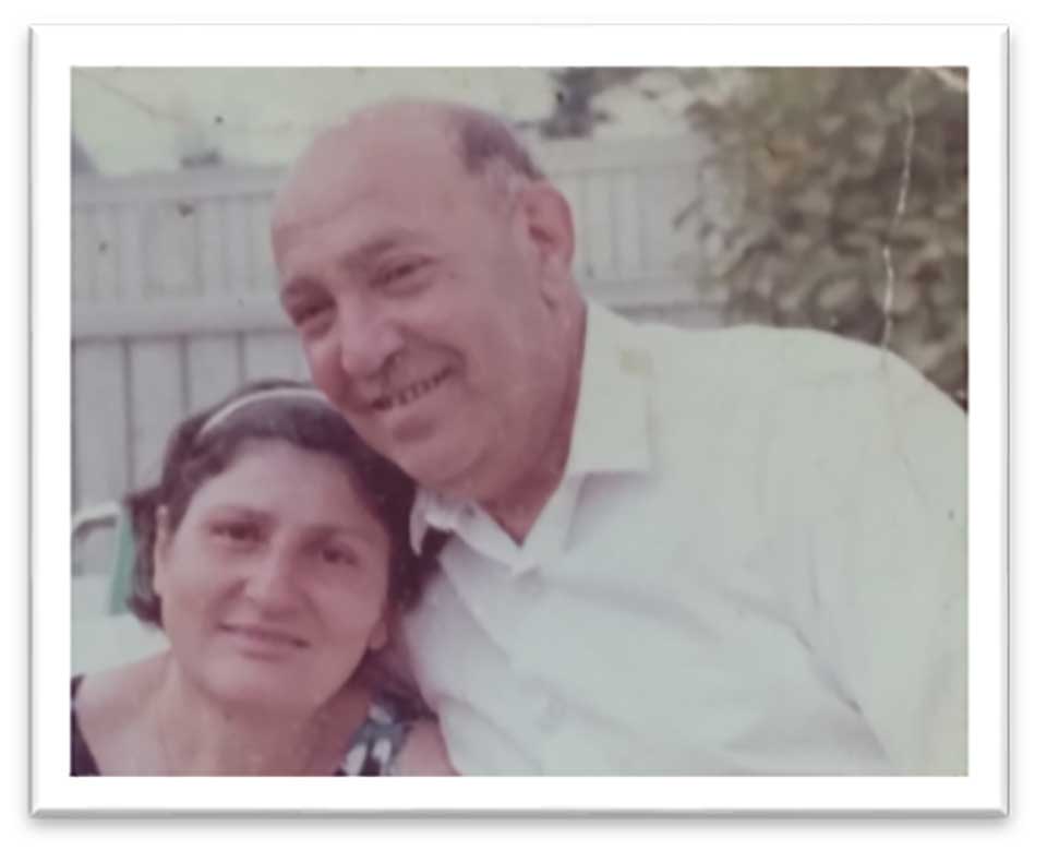 A faded color photograph of the author's grandparents