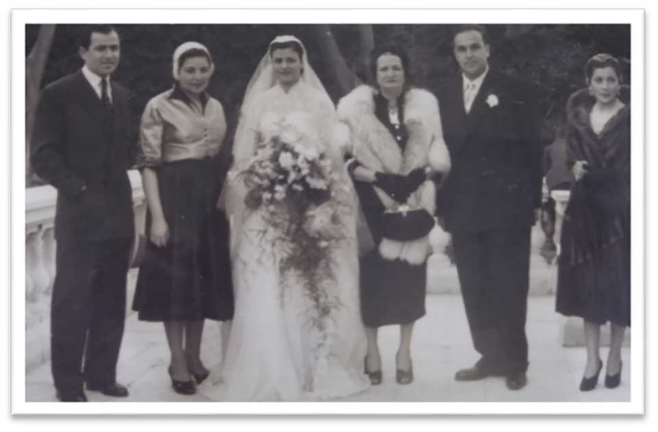 A black and white photograph of a wedding party