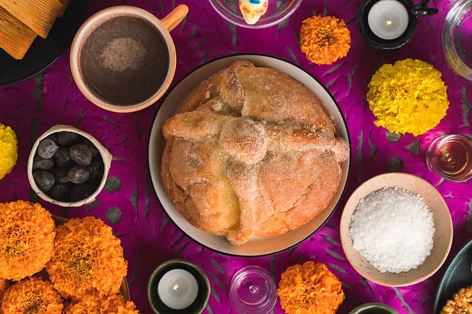 A photograph of a table from above. A pie dominates the center with various ingredients positioned in small bowls in orbit around it