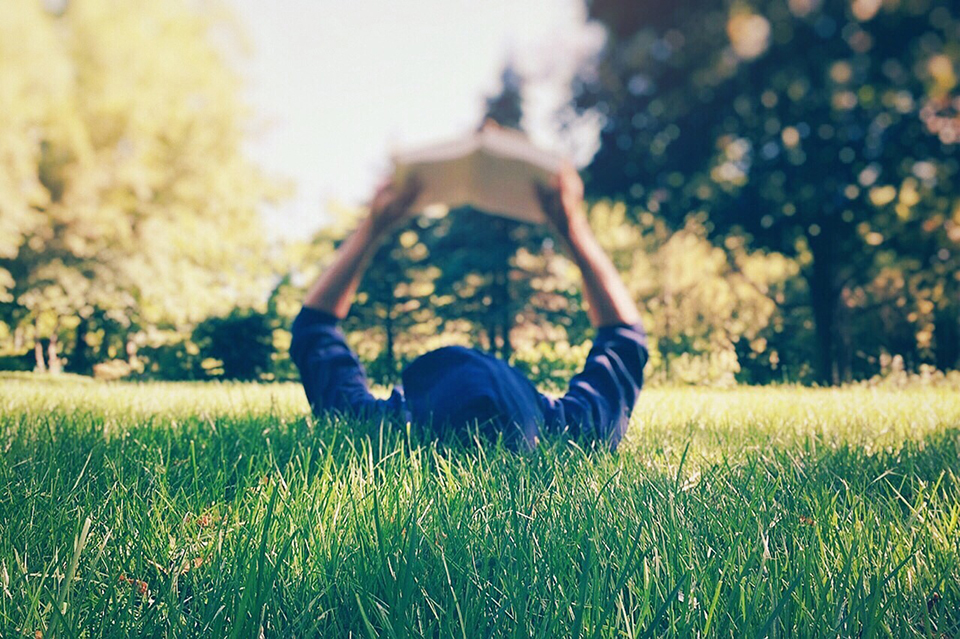 Person reading in the grass