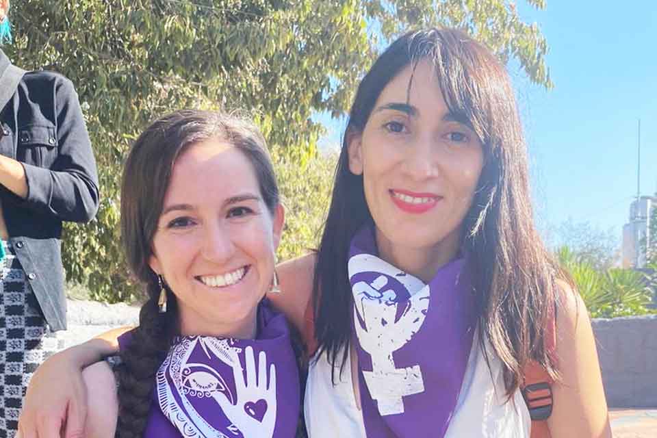 A photograph of Michelle Mirabella and Catalina Infante Beovic taken outdoors at a rally