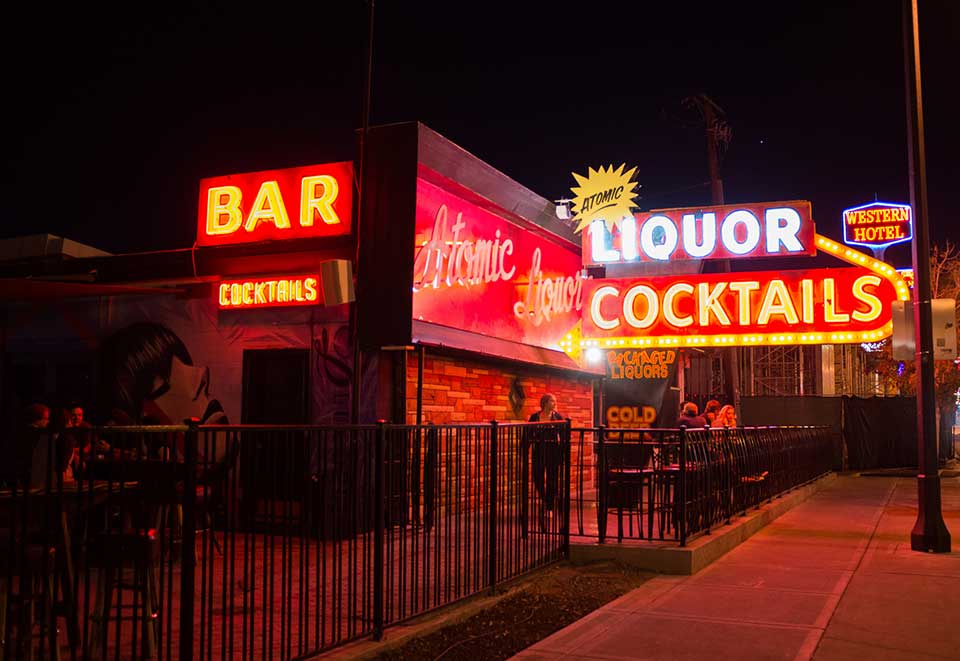 A desultory looking bar, decked with neon signs, presumably in Las Vegas