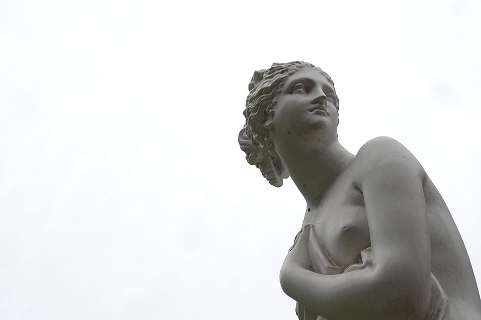 A cropped photo of a Greek statue against a white background