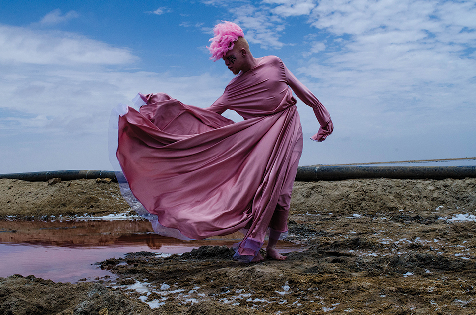 A photograph of a pink clothed figure