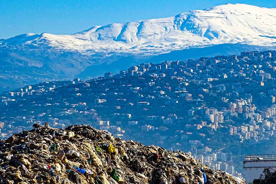 A photograph taken high on a mountain looking down at the city in the valley below