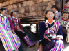 A small clutch of elderly women with face tattoos, garbed in native dress