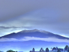 A photograph of a distant snow covered mountain top