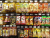 Packaged foods hang uniformly from wall pegs in a Japanese convenience store