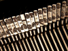 A photograph of the row of arms on a manual typewriter 