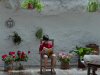 A boy sits in a chair reading in front of a wall