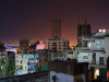 A photograph looking over the roof line at the city of Beirut at night