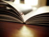 Open book on a desk in sunlight