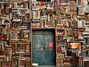 A wall of books with a blue door.