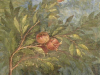 A painting of a pomegranate still on the branch done al fresco on an ancient and cracking wall