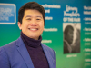 Jeremy Tiang posing in front of materials at the London Book Fair