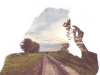 The negative outline of a person blowing on a dandelion through which a photograph of a dirt road stretching into the distance can be seen