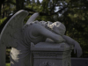 A sculpted angel throws herself across a grave in a show of grief