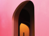 A photograph of a door in a pink wall through which we can see another doorway that opens into an orange room