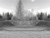 A black and white photograph of a crater, now covered with grass