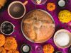 A photograph of a table from above. A pie dominates the center with various ingredients positioned in small bowls in orbit around it