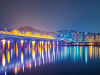 A city skyline reflected in a bay at night