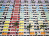 A photograph looking up the front of a colorful apartment building