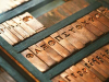 A photograph of Greek letters inscribed in typographical brass fonts