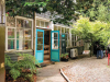 Photo of the exterior of a bookstore swallowed up by trees