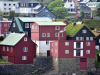 Colorful, geometrically tangent houses cascade up a hill