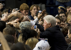 Bill Clinton shaking hands with students