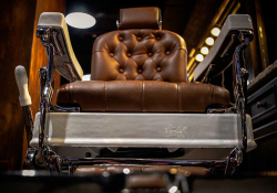 A photograph of a barber's chair as seen from the ground in front of it