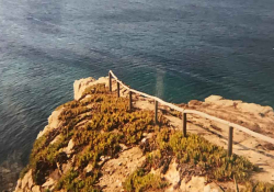 A rough dirt road terminates at the end of a point that sits on a cliff above a wine-dark sea