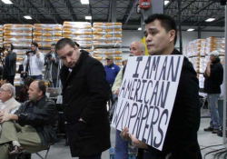 Jose Antonio Vargas holds a sign at a Mitt Romney presidential campaign rally in 2011 in a scene from his film “Documented.” Photo courtesy of Apo Anak Productions.