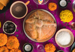 A photograph of a table from above. A pie dominates the center with various ingredients positioned in small bowls in orbit around it