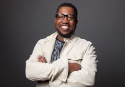 Major Jackson, in a white sport coat and smiling at the camera