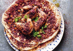 A photograph of flatbread with spices baked into the surface